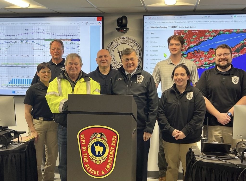 Members at a Podium with weather graphs behind them