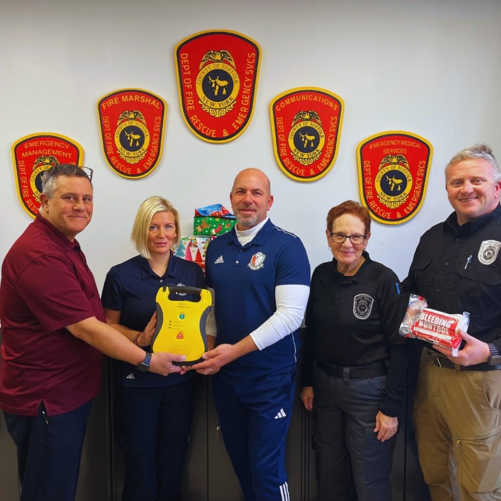 Bleed Team holding AED